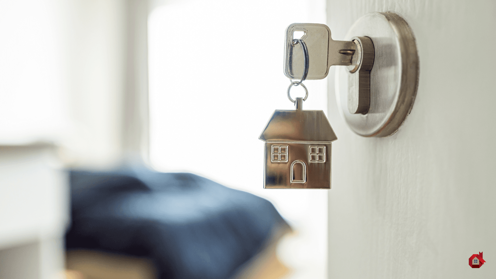 Keys in a door with a house