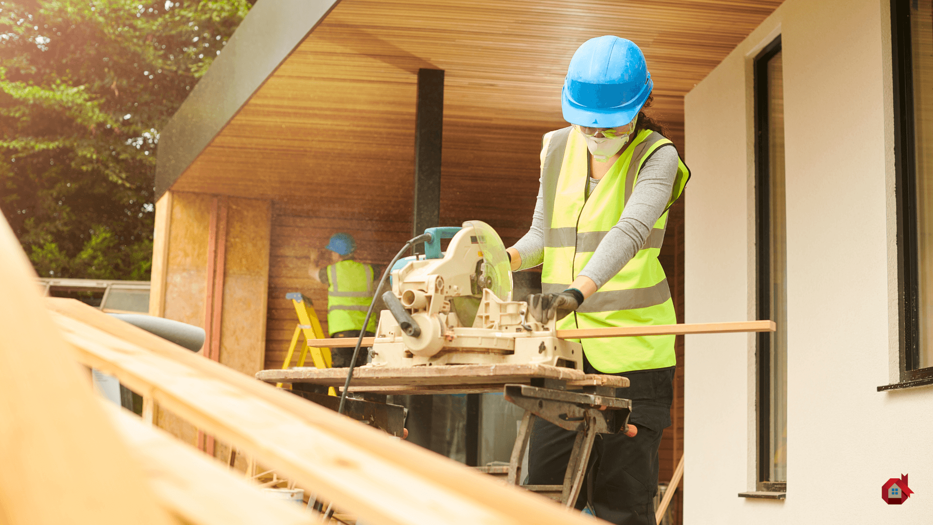 two contractors putting wood siding on a house&nbsp;