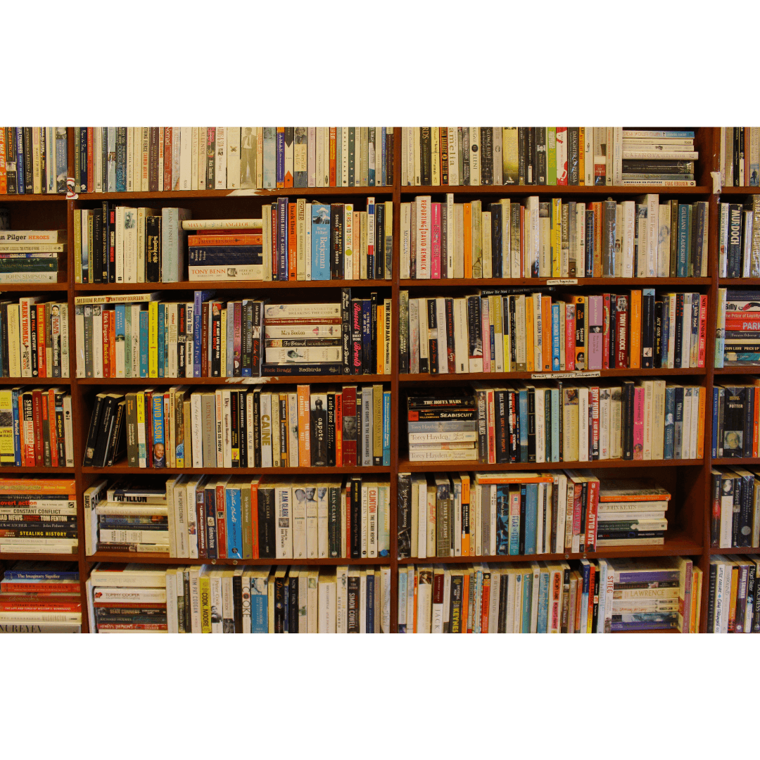 A wooden bookshelf filled with a variety of books, representing literary culture and the perfect organization of a love for reading.