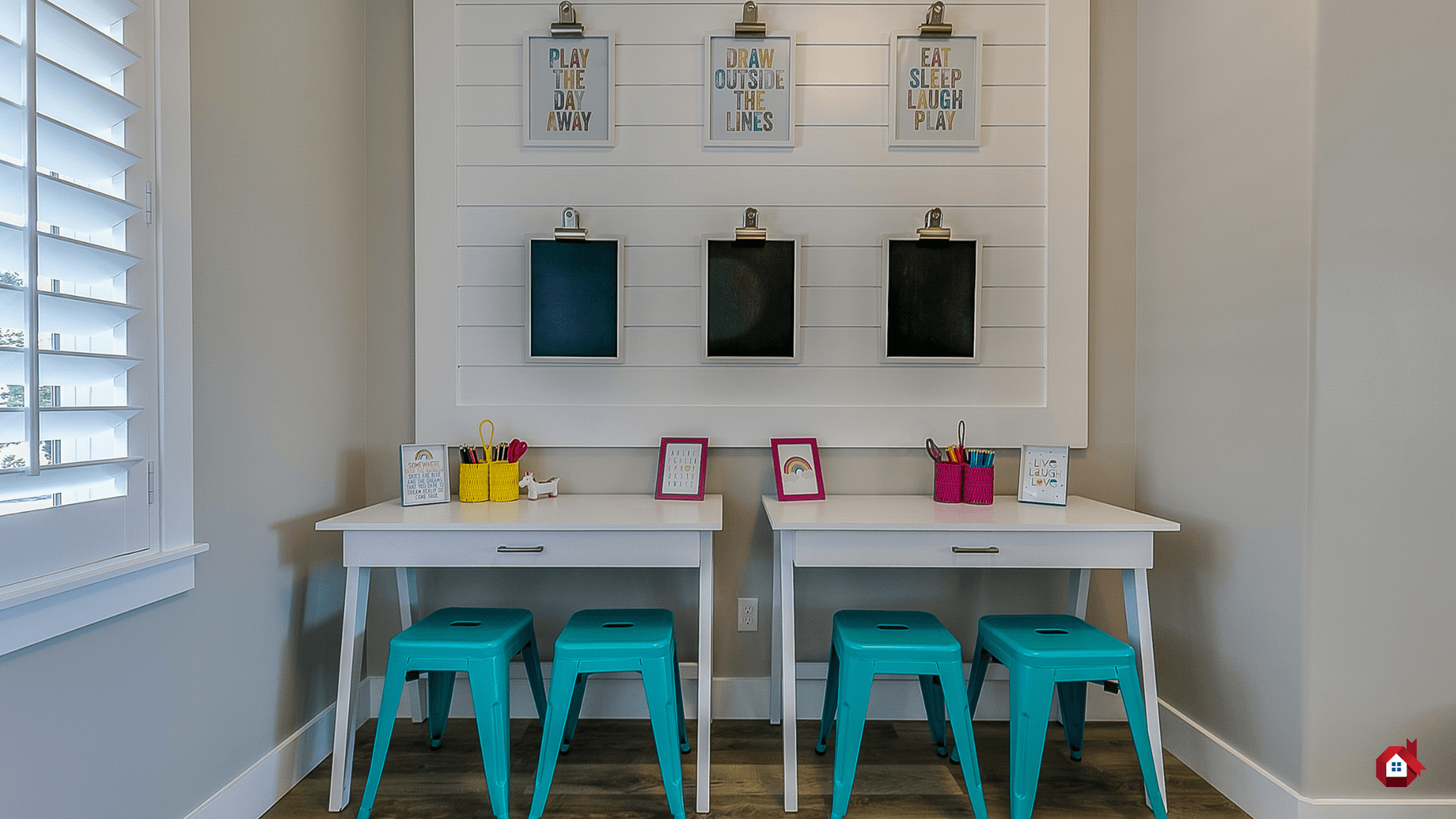 Kids’ creative corner with two desks, blackboards, and inspiring wall decor