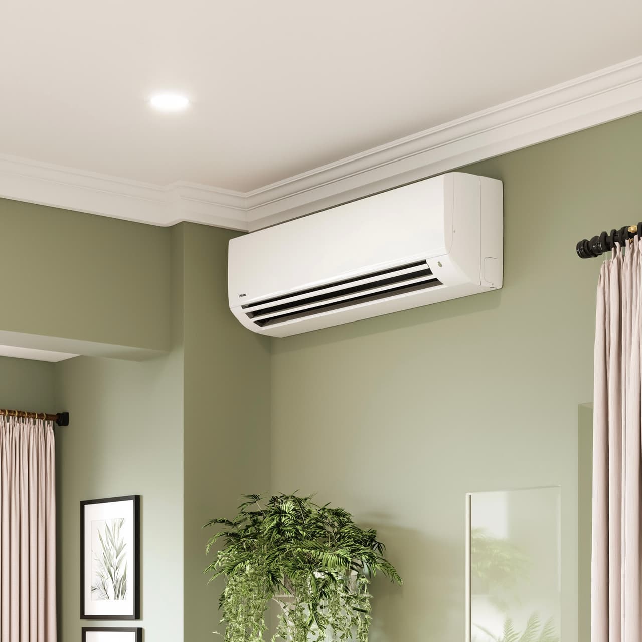 White wall-mounted air conditioner installed in a modern living room with green walls, white moldings and indoor decorative plant.