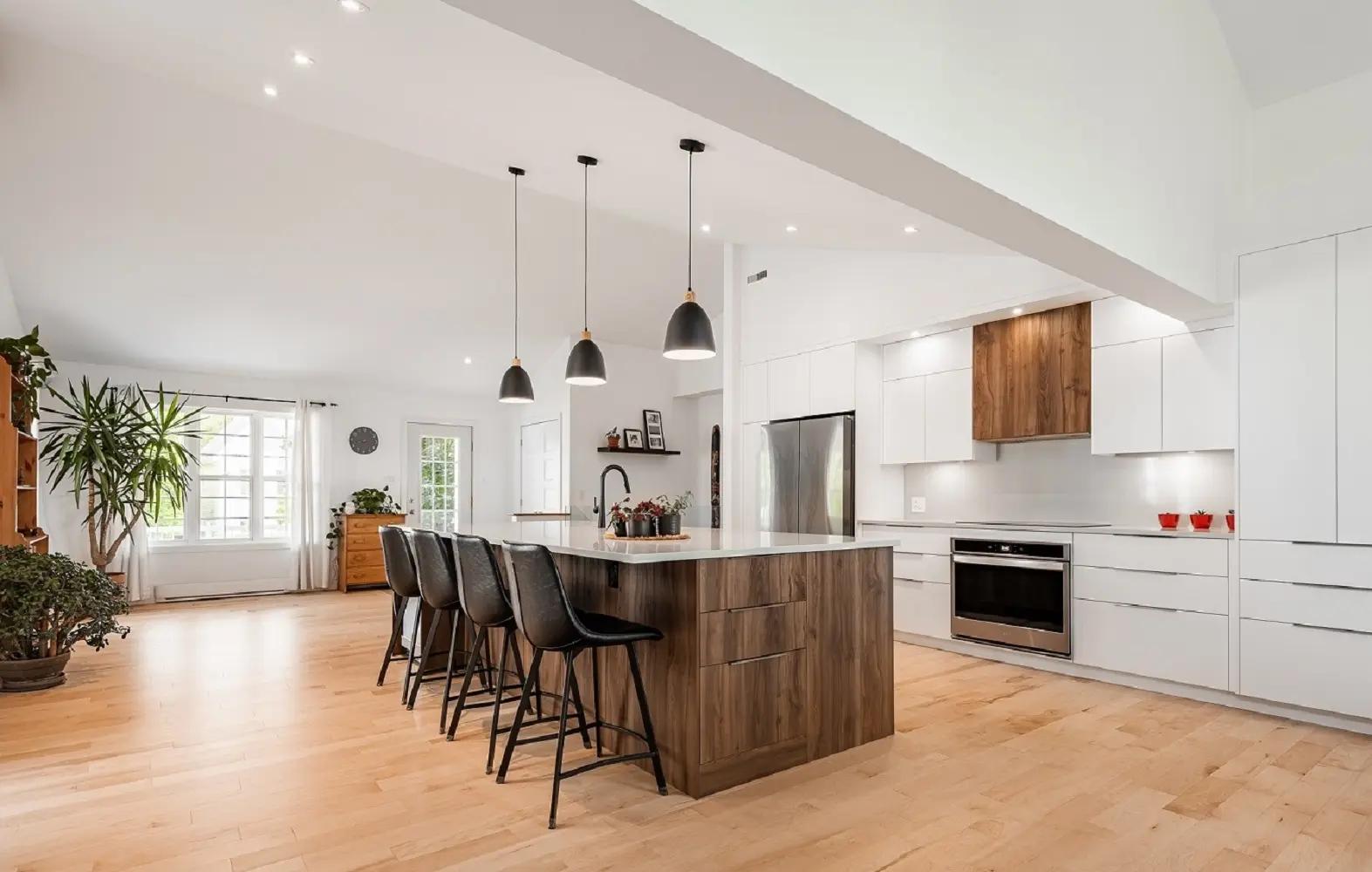 Scandinavian kitchen with a contemporary twist. The mix of light wood, white and black creates a warm, uncluttered atmosphere. The central island is perfect for meals with family and friends.