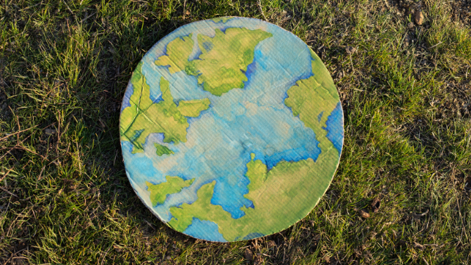 painting table in form of planet earth put on grass&nbsp;