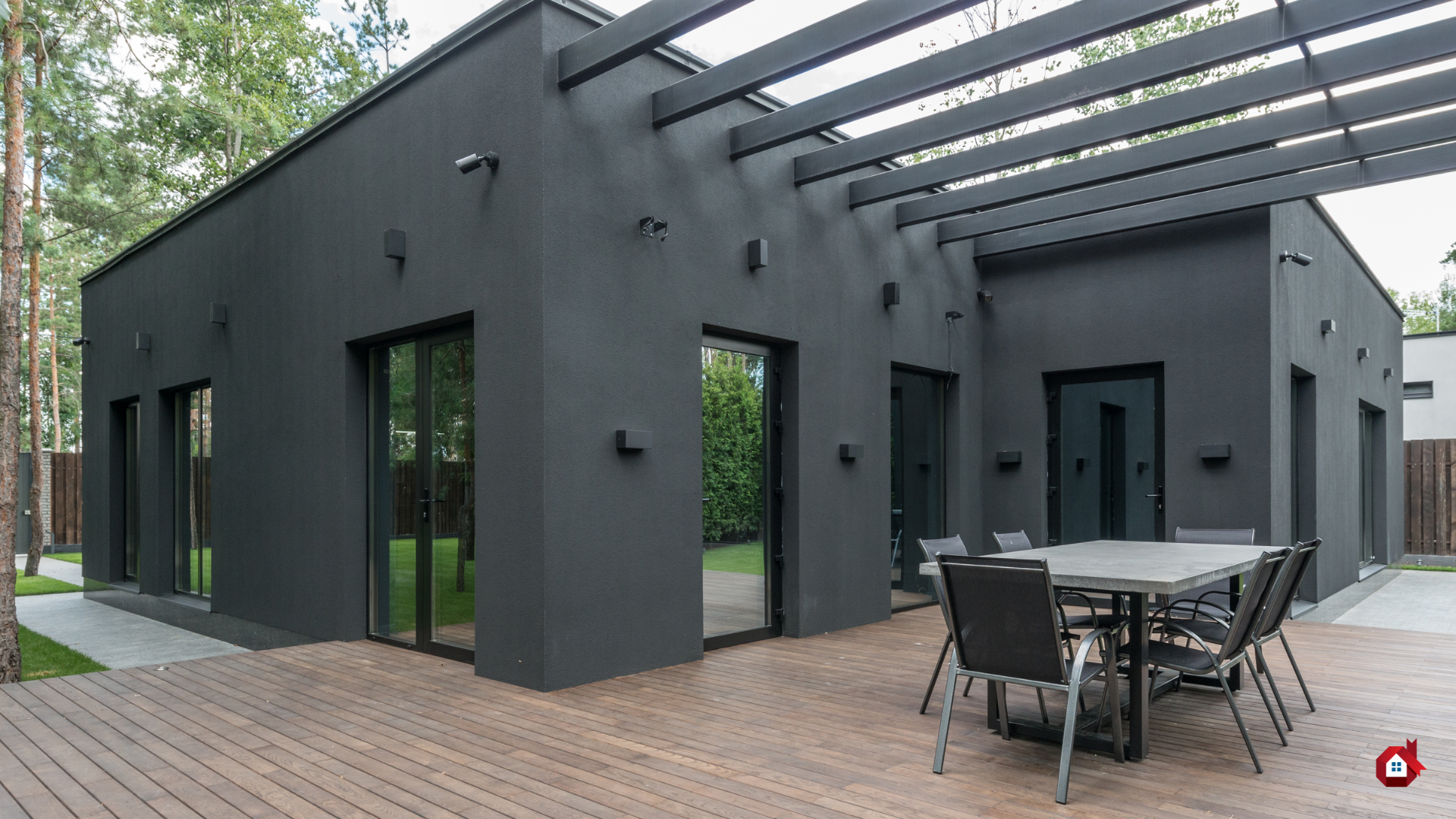 house with black facade and wooden terrace 