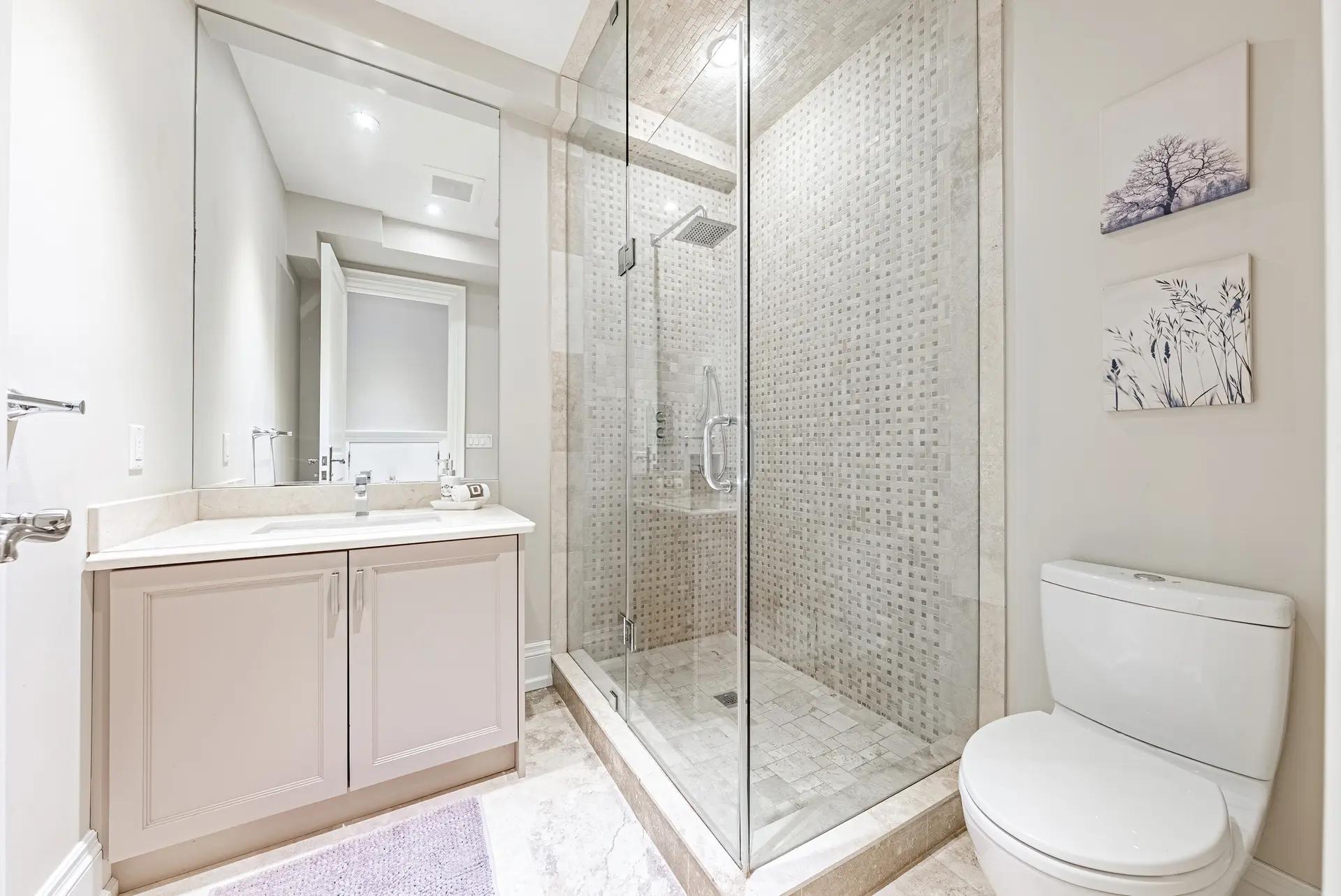 Modern bathroom with a glass shower and light wood vanity