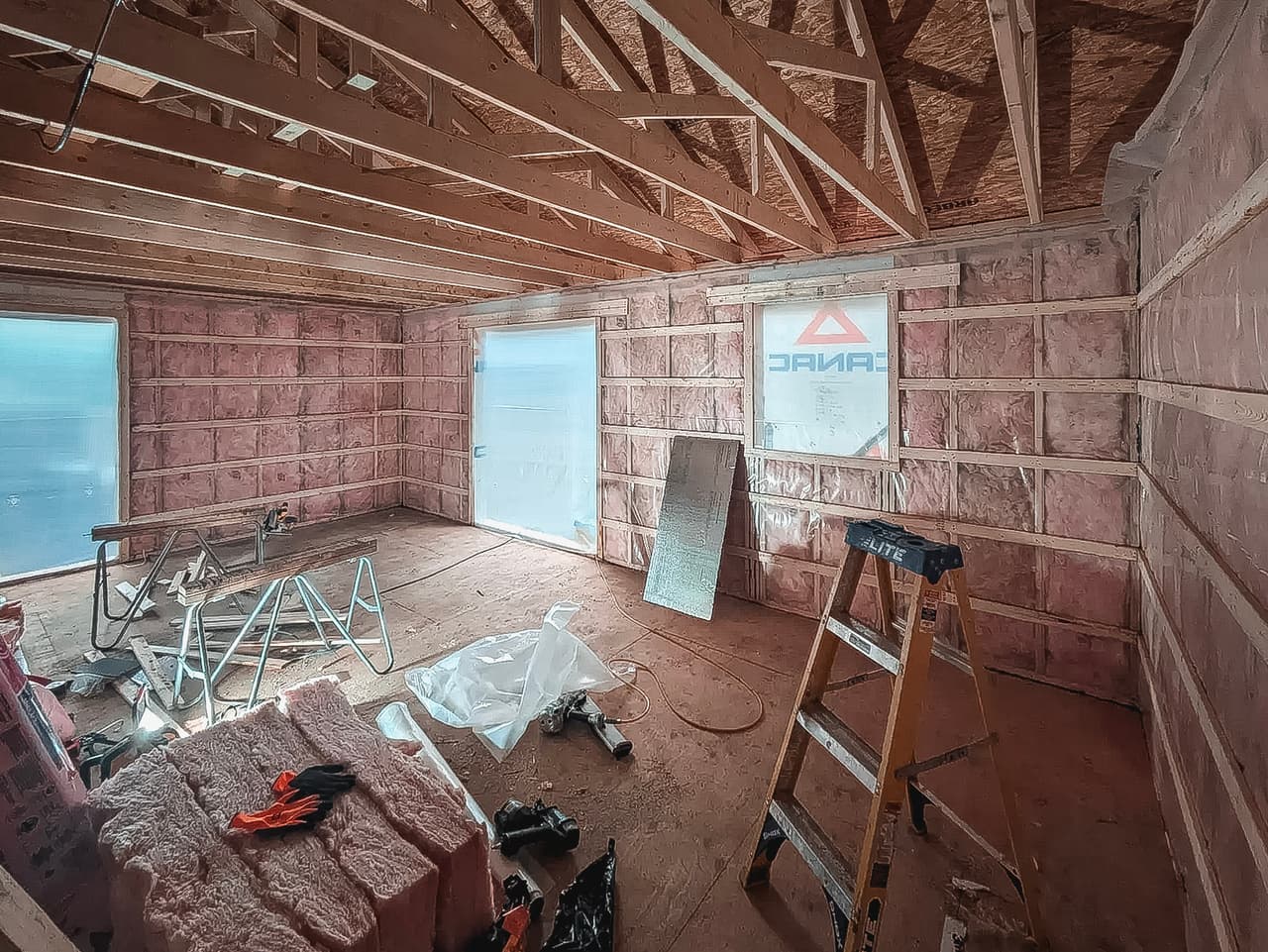 Home under renovation with exposed insulation and wooden framing, illustrating a project requiring a qualified contractor