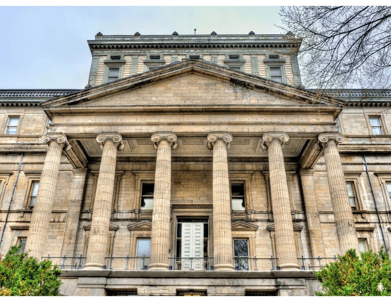 Imposing facade of a stone courthouse with classical columns.