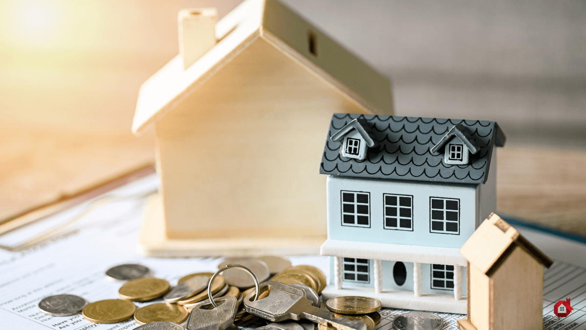 cardboard house with coins on the side