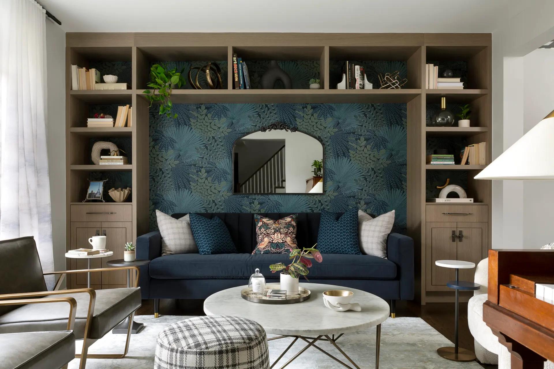 Modern living room featuring a blue sofa adorned with matching blue cushions, surrounded by contemporary furniture and minimalist decor.