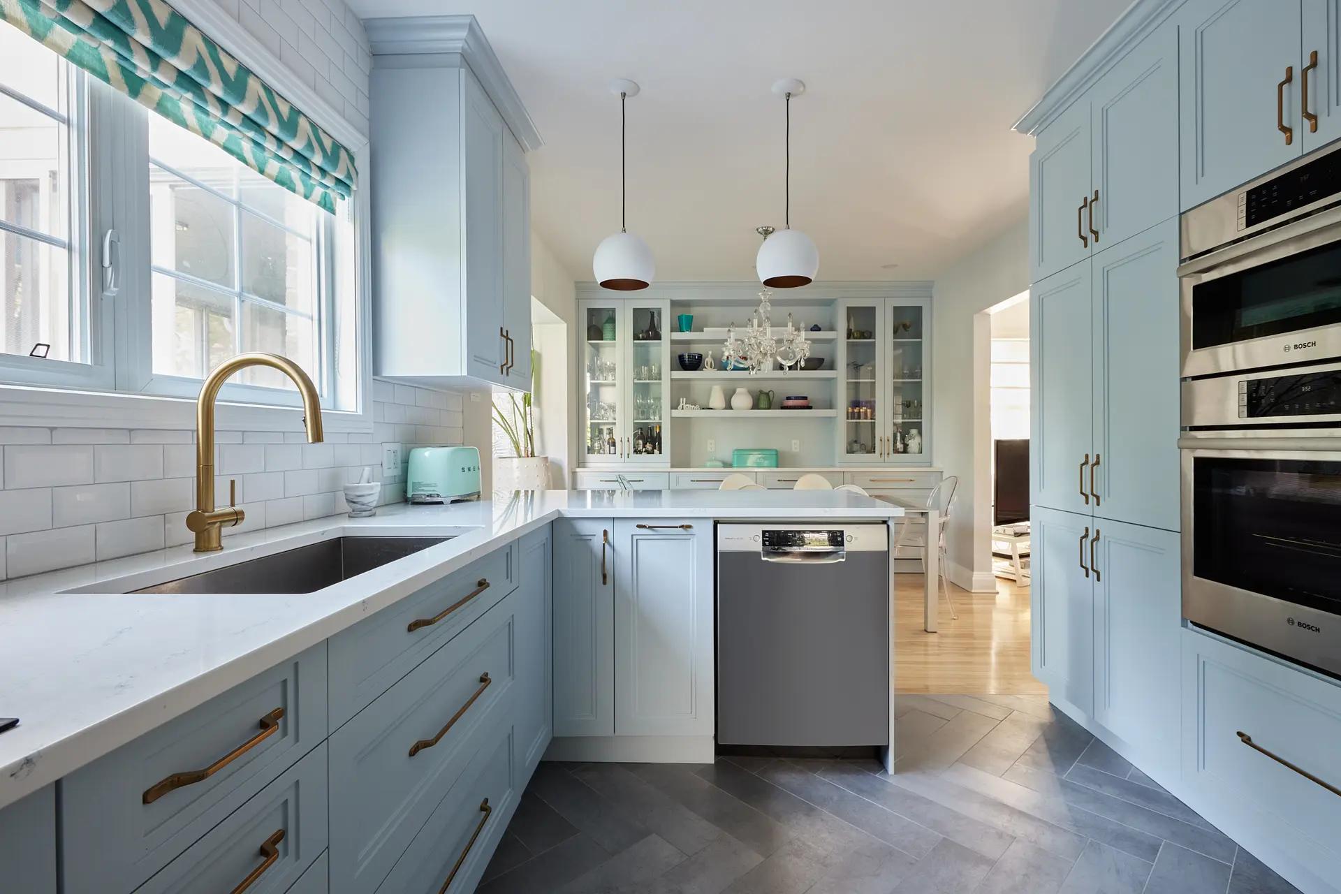  country chic kitchen with a mix of pastel colors and natural materials. The light blue of the cabinets adds a fresh touch to this bright space.