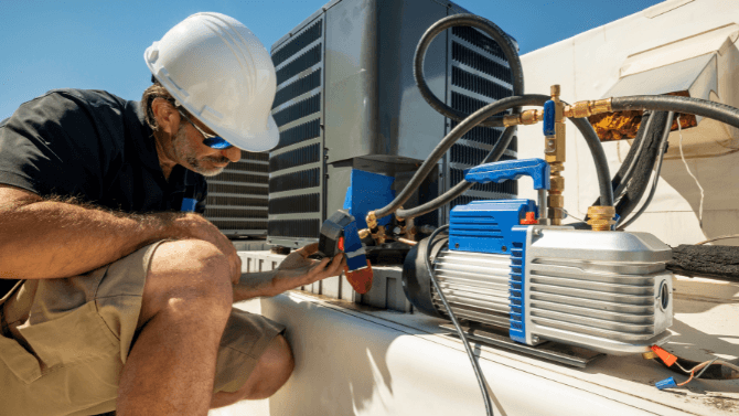 Technician on a rooftop reparing an air system 
