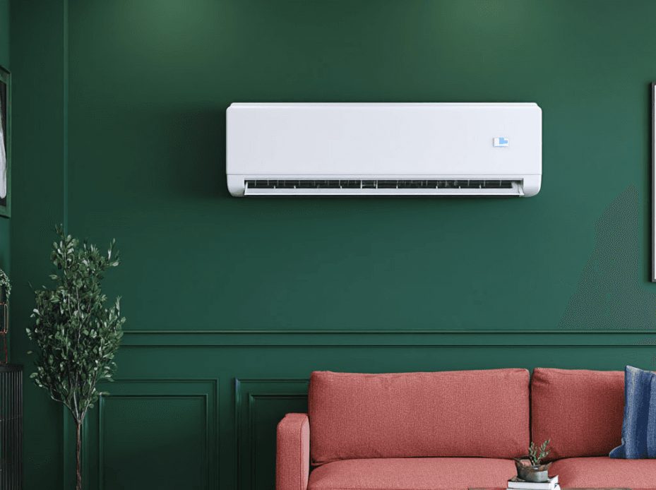 Modern living room with red sofa, dark green wall, and white wall-mounted air conditioner installed above