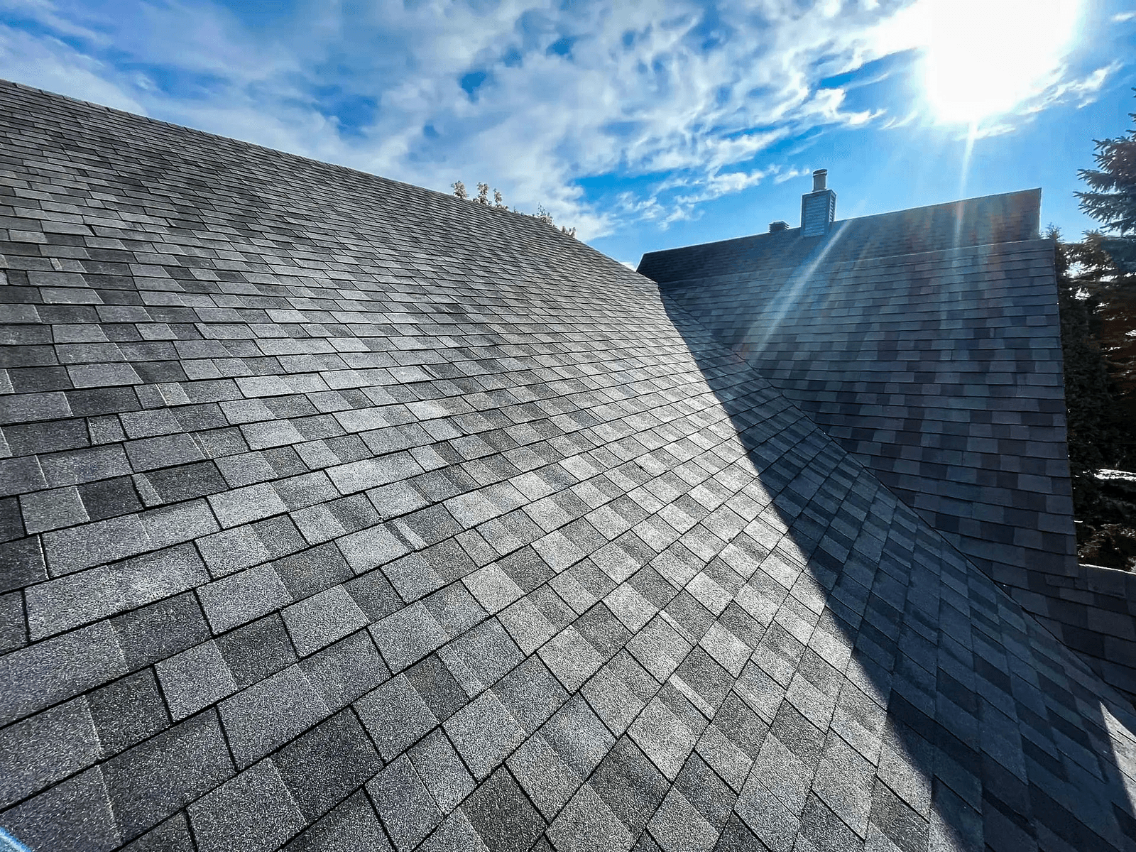 Modern asphalt shingle roof under natural light on a sunny day.