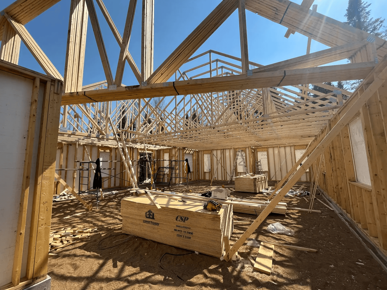 Wooden framework of a house under construction with exposed roof trusses