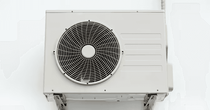 Outdoor heat pump or mini-split air conditioning unit with a large circular fan and white housing.