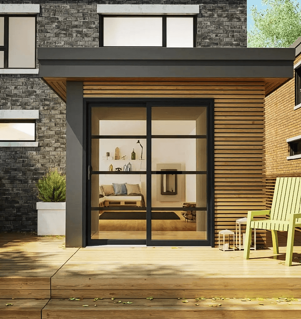Modern residential extension with large black glass door, horizontal wood exterior siding, wooden deck and contemporary dark brick facade.