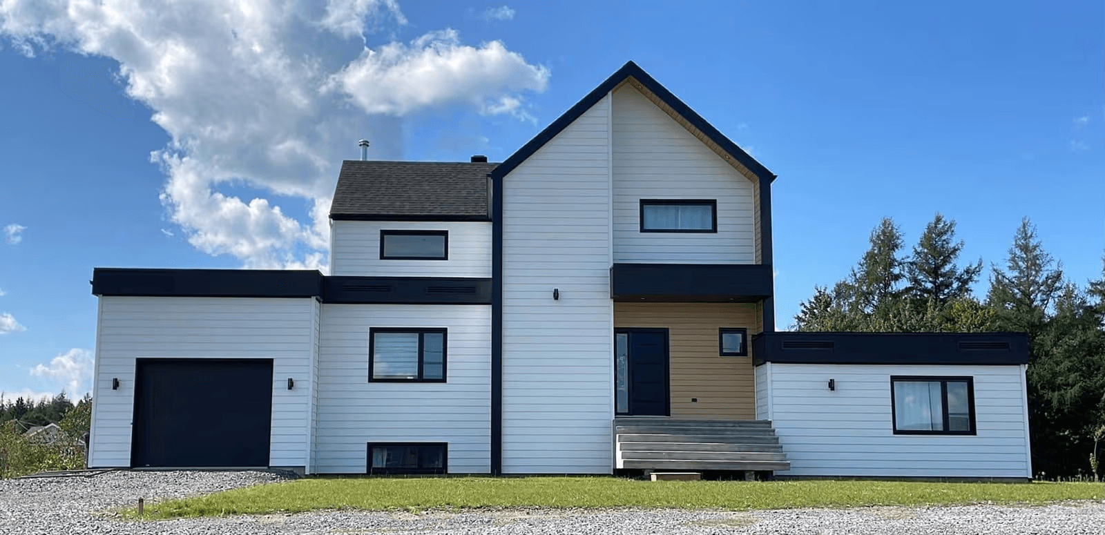 Modern two-story house with white exterior siding and black accents, attached garage and elevated entrance
