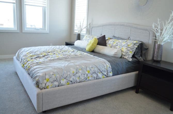 Gray bedroom with yellow white and gray bedcover