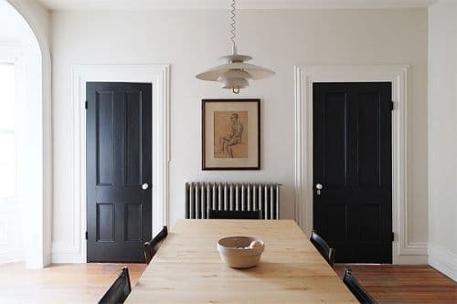 white walls with black doors in dining room