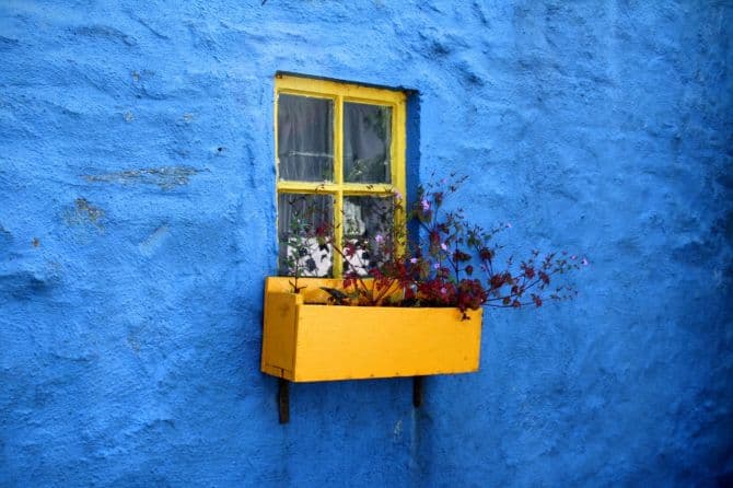 yellow window on blue wall finish_repairing or replacing your windows?