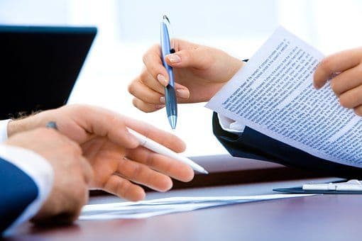 someone signing a contract_Renovation Contract: Understanding the Clauses