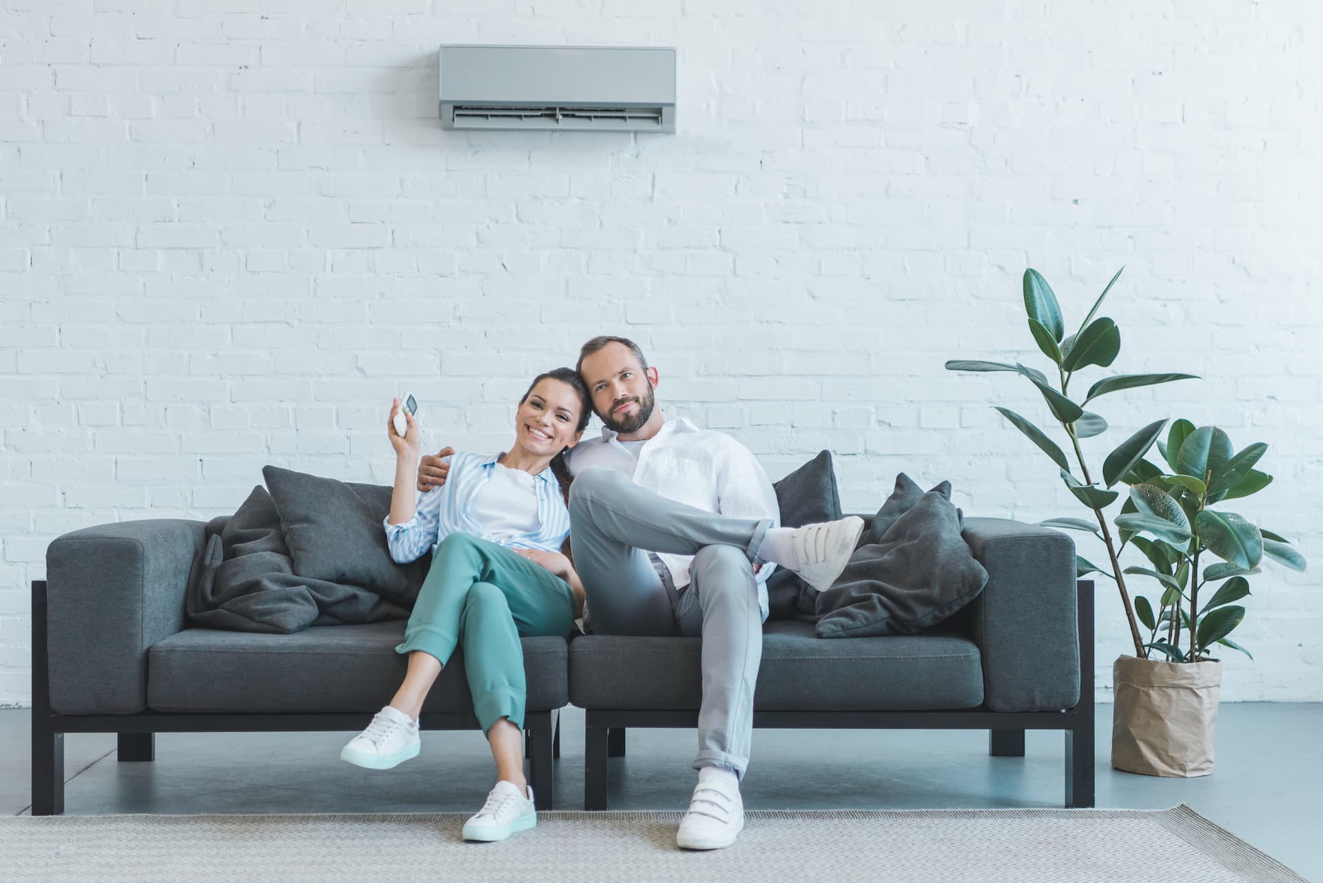 Couple in living room with wall mounted air conditioner