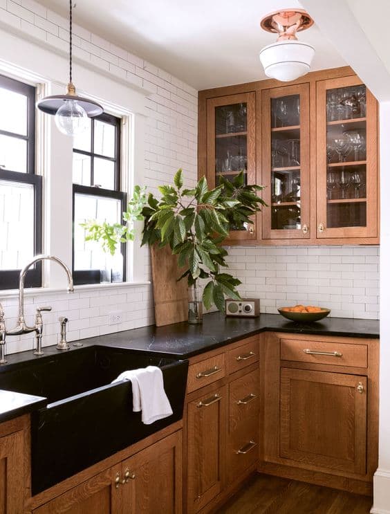 black sink in wood-accented kitchen_10 Examples of Black Kitchen Sinks