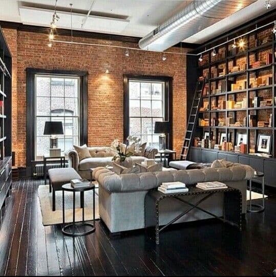 Salon mur de briques avec étagères noires_brick wall living room with black shelves
